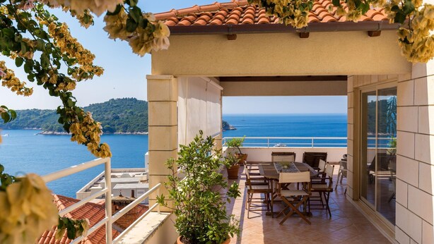A terrace with a view of the sea, potted plants, and outdoor furniture. - Hedera Estate, Hedera A14 (Dubrovnik)