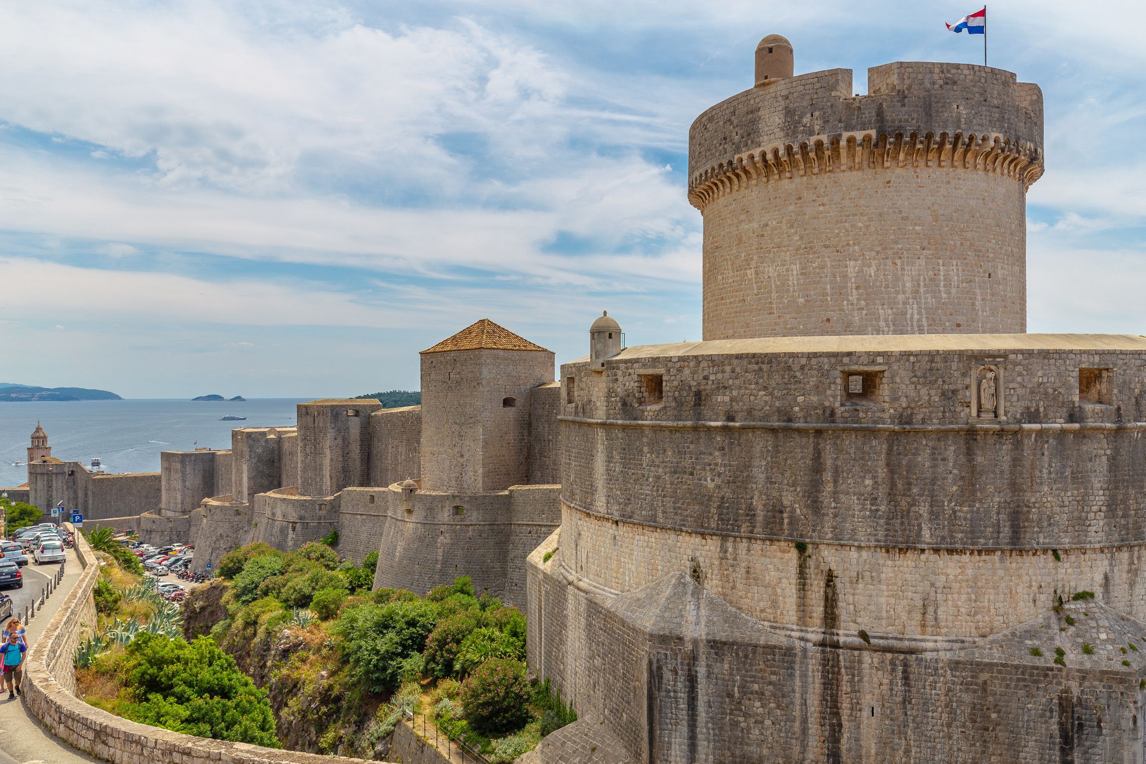A historic stone castle with multiple towers and a flag on top.