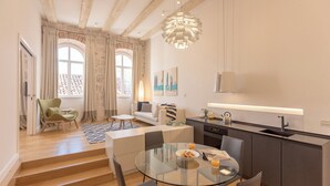 A modern kitchen with a dining area, a staircase, and a view of the outside. - Hedera Estate, Hedera A4 (Dubrovnik)