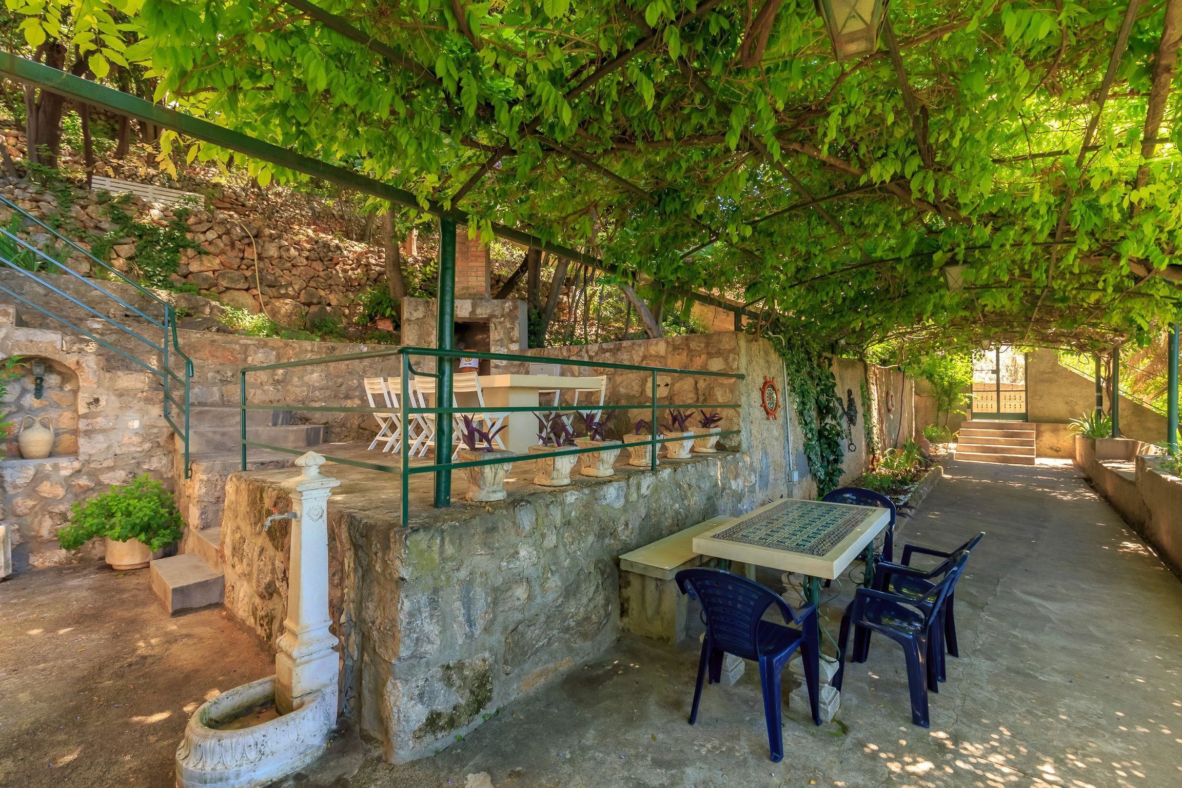 An outdoor patio with stone steps, a table, and chairs.