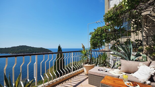A balcony with a view of the sea, outdoor furniture, and potted plants. - Hedera Estate, Hedera A17 (Dubrovnik)