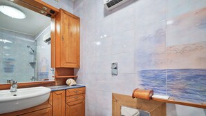 A bathroom with a wooden vanity, a sink, a toilet, and a shower. - Hedera Estate, Hedera A17 (Dubrovnik)