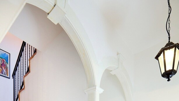 A wooden staircase with a black handrail, white walls, and a hanging lantern. - Hedera Estate, Hedera A34 (Dubrovnik)