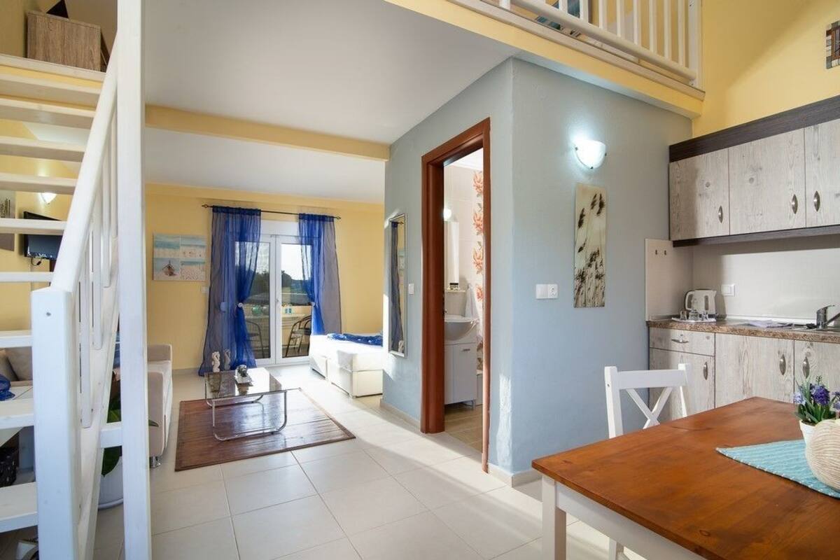 Deluxe Duplex | Living area | Flat-screen TV