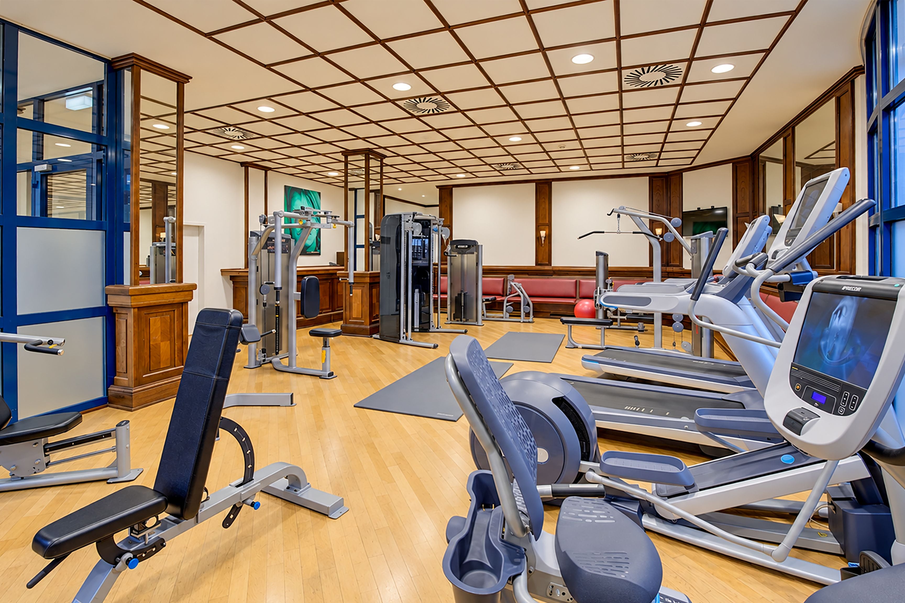 A gym with various exercise equipment, including treadmills and weight machines.