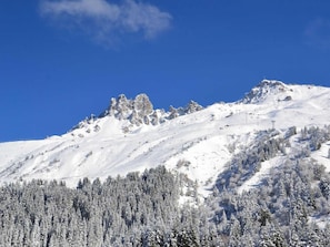 Surrounded by snow-covered mountains and rocky outcrops, this serene landscape offers breathtaking views.