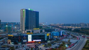 A high-rise hotel with multiple floors and a prominent sign at the top. - Holiday Inn Express Ningbo Fenghua by IHG (Ningbo)