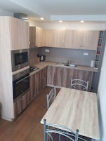 Exclusive Apartment | Private kitchen | Full-size fridge, microwave, oven, stovetop