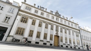 A historic building with a symmetrical facade, large windows, and statues on the roof. - Apartment with Private Terrace (Copenhagen)
