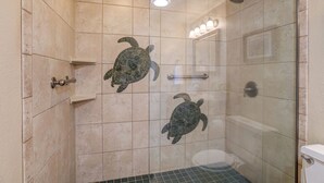 A glass-enclosed shower stall with a tiled floor and a glass door. - Uninterrupted Ocean views, 70" of Entertainment (Wailuku)