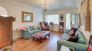 A spacious living room with hardwood floors, a chandelier, and a large window. - Retreat w/ Pond Access & Views in Temple (Temple)