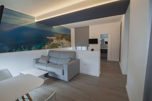 Premium Double Room (El Faro) | Living room | Flat-screen TV - Hostal Sa Vinya Suites (Sant Joan de Labritja)