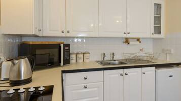 Apartment, Multiple Beds | Private kitchen | Fridge, microwave, oven, stovetop