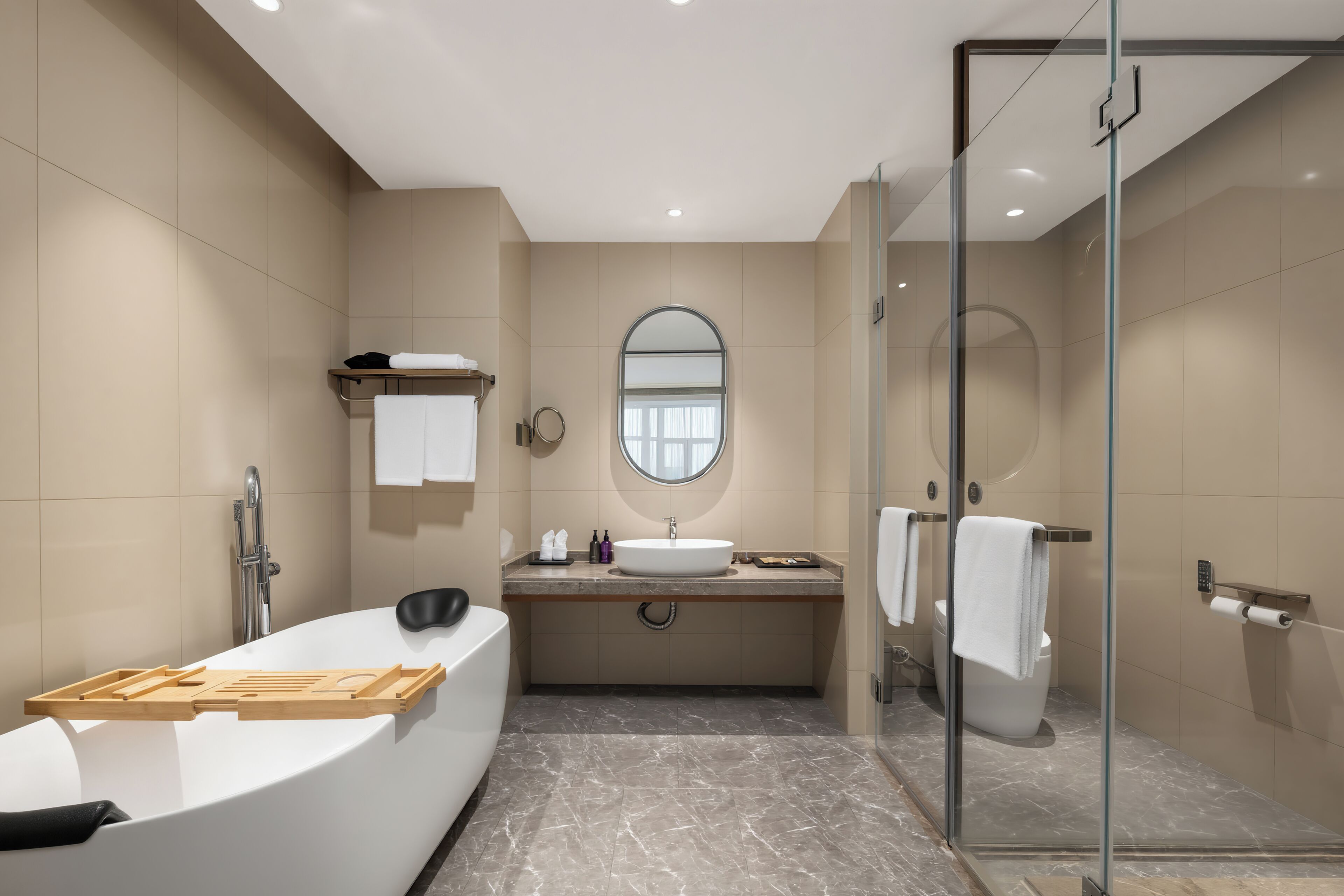 A modern bathroom with a freestanding bathtub, a vanity with a mirror, and a glass-enclosed shower.