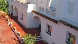 A white building with multiple arches and a red-tiled roof. - Rancho Grande (Marbella)