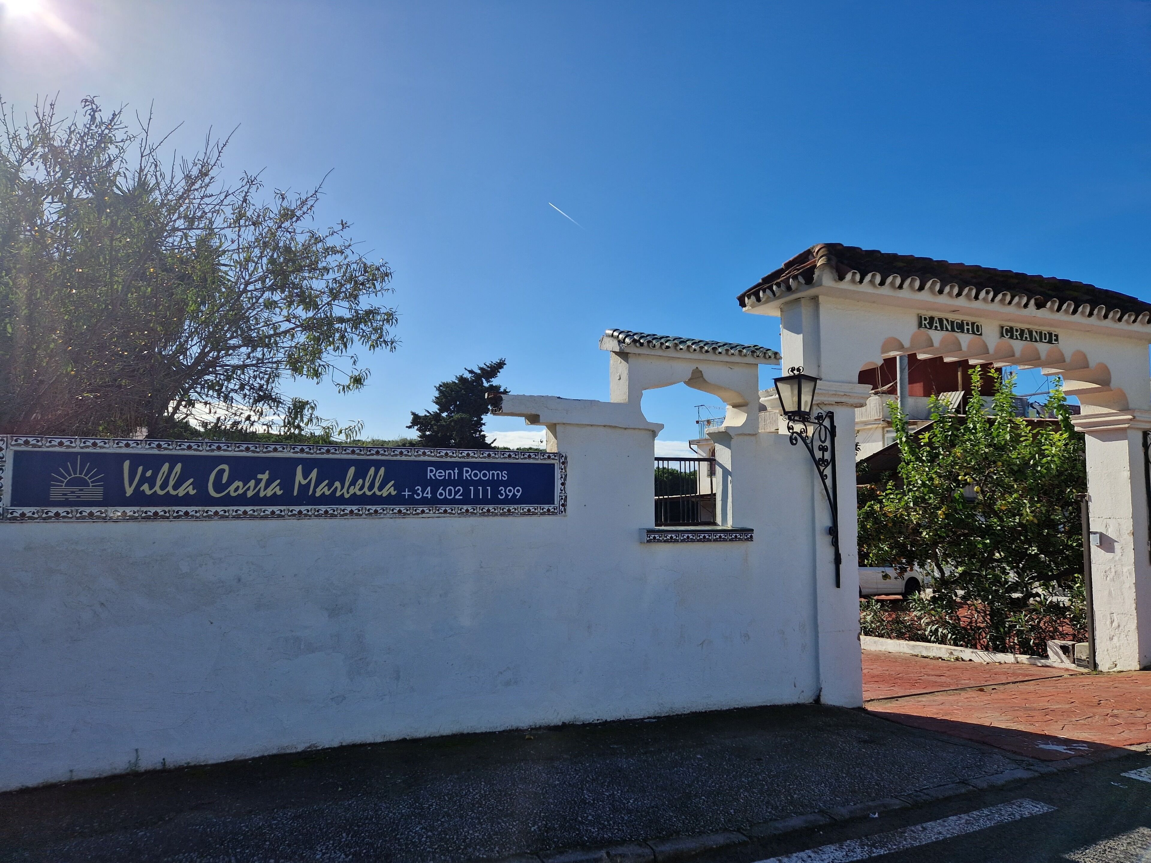 A sign for Villa Costa Marbella with a contact number.