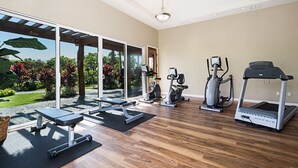 A home gym with a treadmill, elliptical, and bench press. - 🏖️Family-Friendly | Pools, Beach Gear, Golf & Walk to A-Bay Adventures (Waikoloa)
