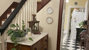 A wooden staircase with white railings and a checkered floor leading to a kitchen area. - OCNJ Gold Coast beach home, Pet friendly, 9 houses from the beach and boards!  (Ocean City)