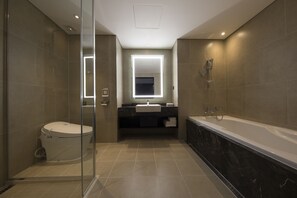 A modern bathroom with a glass-enclosed shower, a toilet, a sink with a mirror, and a bathtub. - Ramada by Wyndham Daejeon (Daejeon)