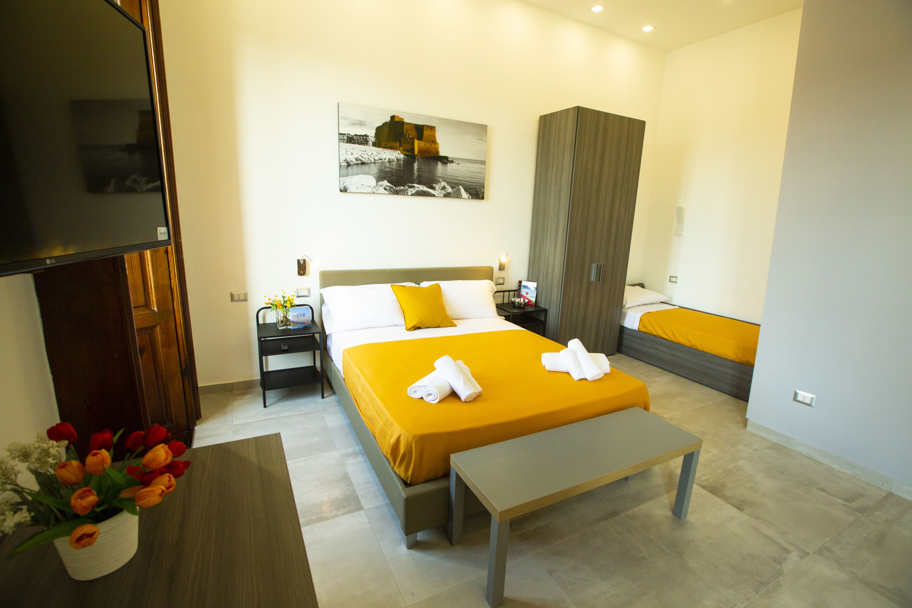 Deluxe Quadruple Room | Down comforters, in-room safe, individually decorated