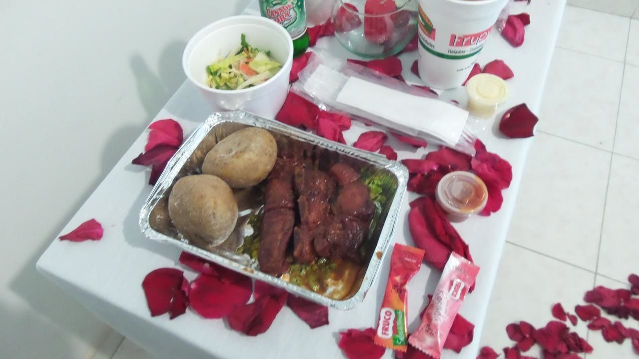 A table with food items and rose petals.