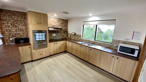Enjoy cooking in this well-equipped kitchen with a stainless steel oven, microwave, and sink.
