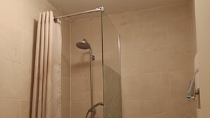 A shower area with a glass door, a showerhead, and a toilet. - Studio 2 Pers. Pines View in Building Facing sea Baie de La Baule (La Baule-Escoublac)