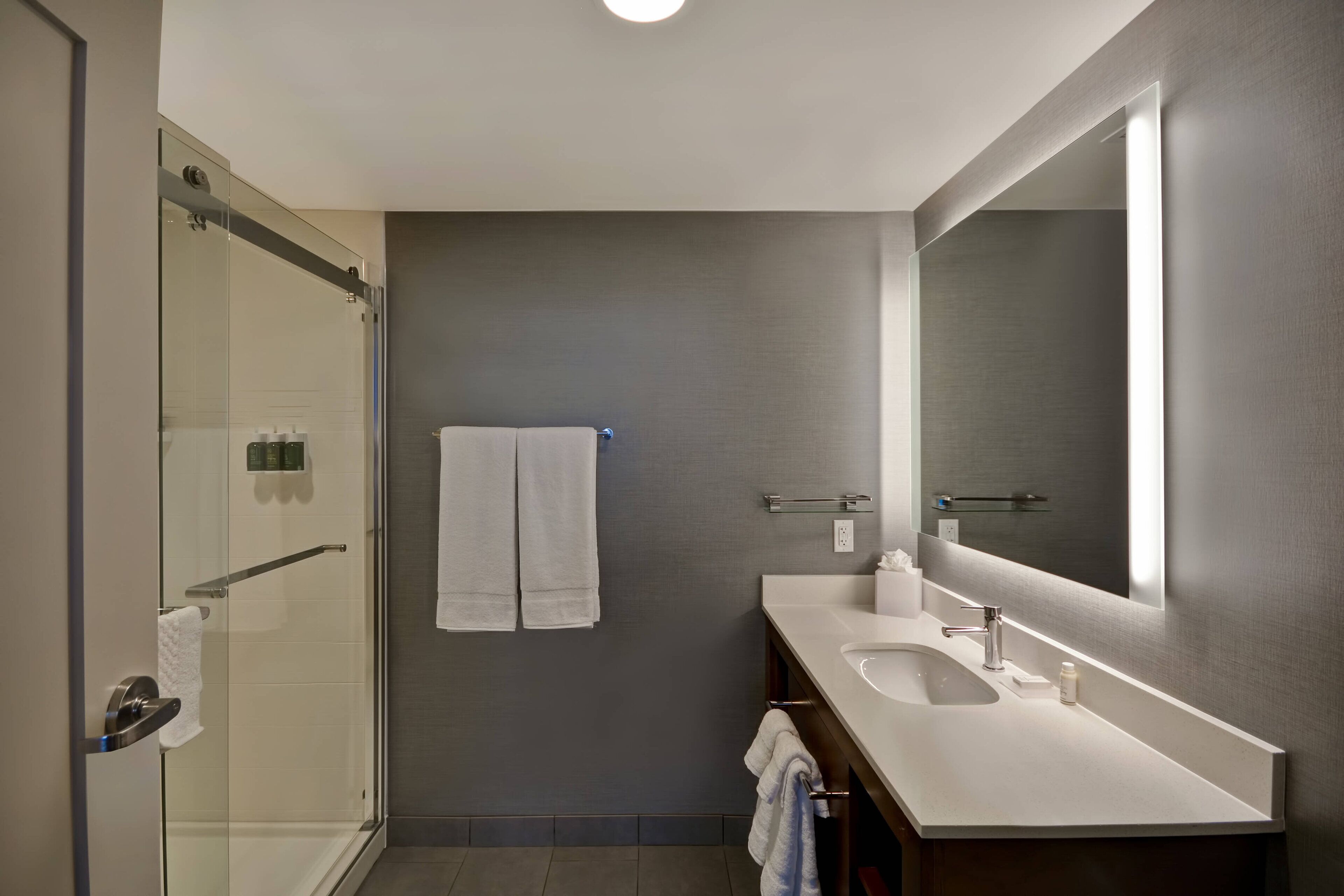 designer toiletries, hair dryer, towels, soap