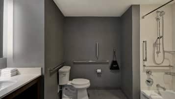 A modern bathroom with a toilet, sink, and shower.