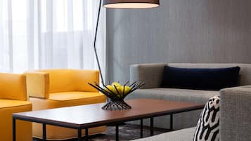 A modern living room with a sofa, a coffee table, and a floor lamp.