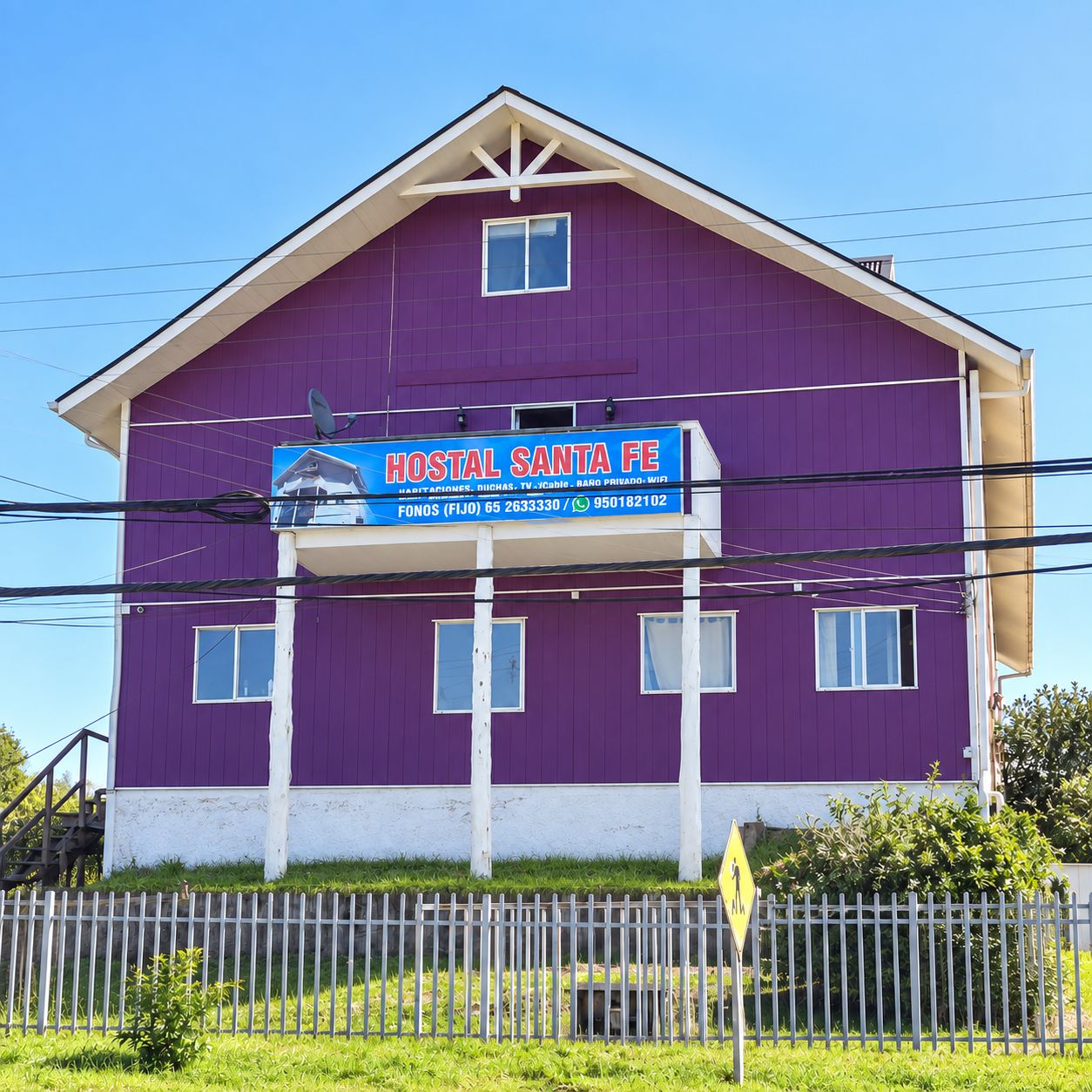 A two-story building with a sign for 'Hostal Santa Fe' indicating it is a hotel.