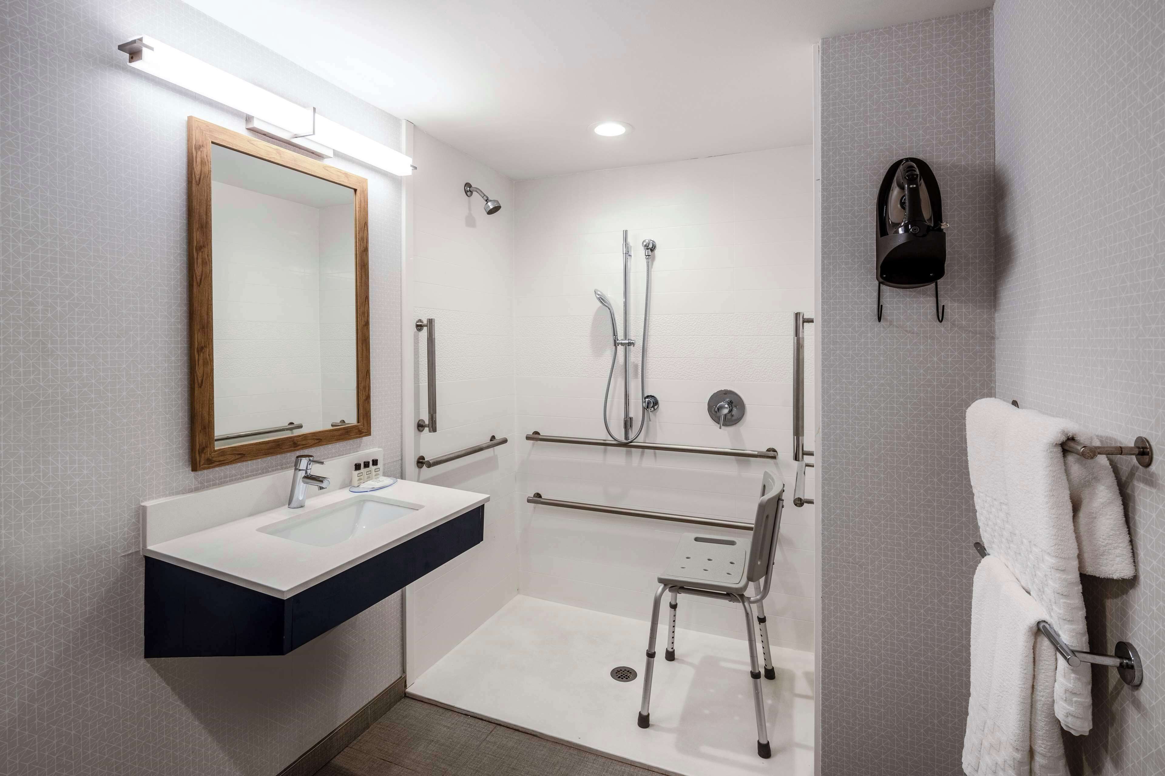 designer toiletries, hair dryer, towels, soap