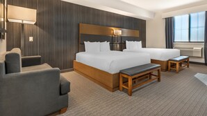A hotel room with a large bed, two bedside tables, a desk, a chair, and a window with curtains. - Executive Residency by Best Western Calgary City View North (Calgary)