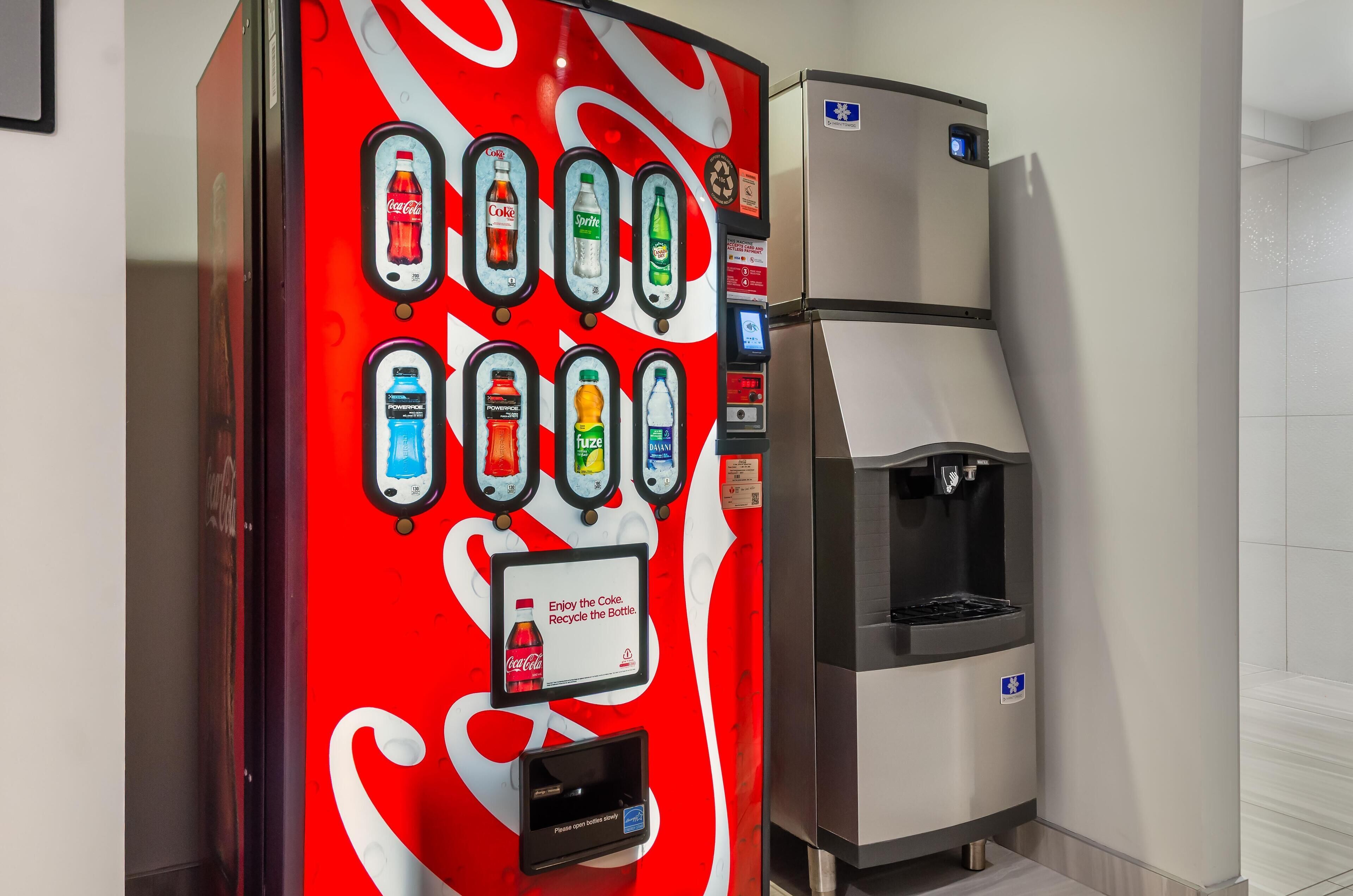 A vending machine with various beverage options and a water dispenser.