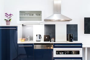 A modern kitchen with a built-in oven, a coffee machine, and a kettle. - Best Western Plus Celebrity Suites (Vienna)