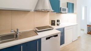 A modern kitchen with a built-in dishwasher, a microwave, and a coffee machine. - Best Western Plus Celebrity Suites (Vienna)