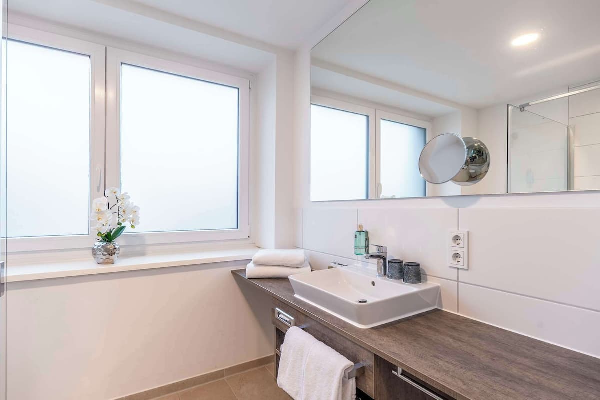 junior suite, 1 king bed | bathroom | shower, rainfall showerhead, hair dryer, towels