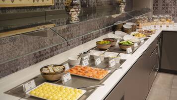 A buffet with various food items and labels.