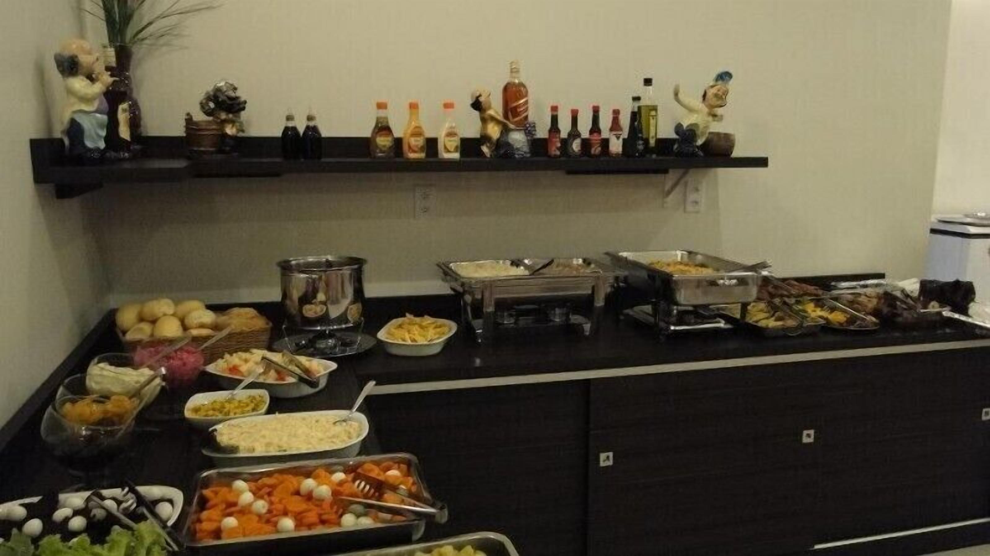 A buffet setup with various food items and condiments.