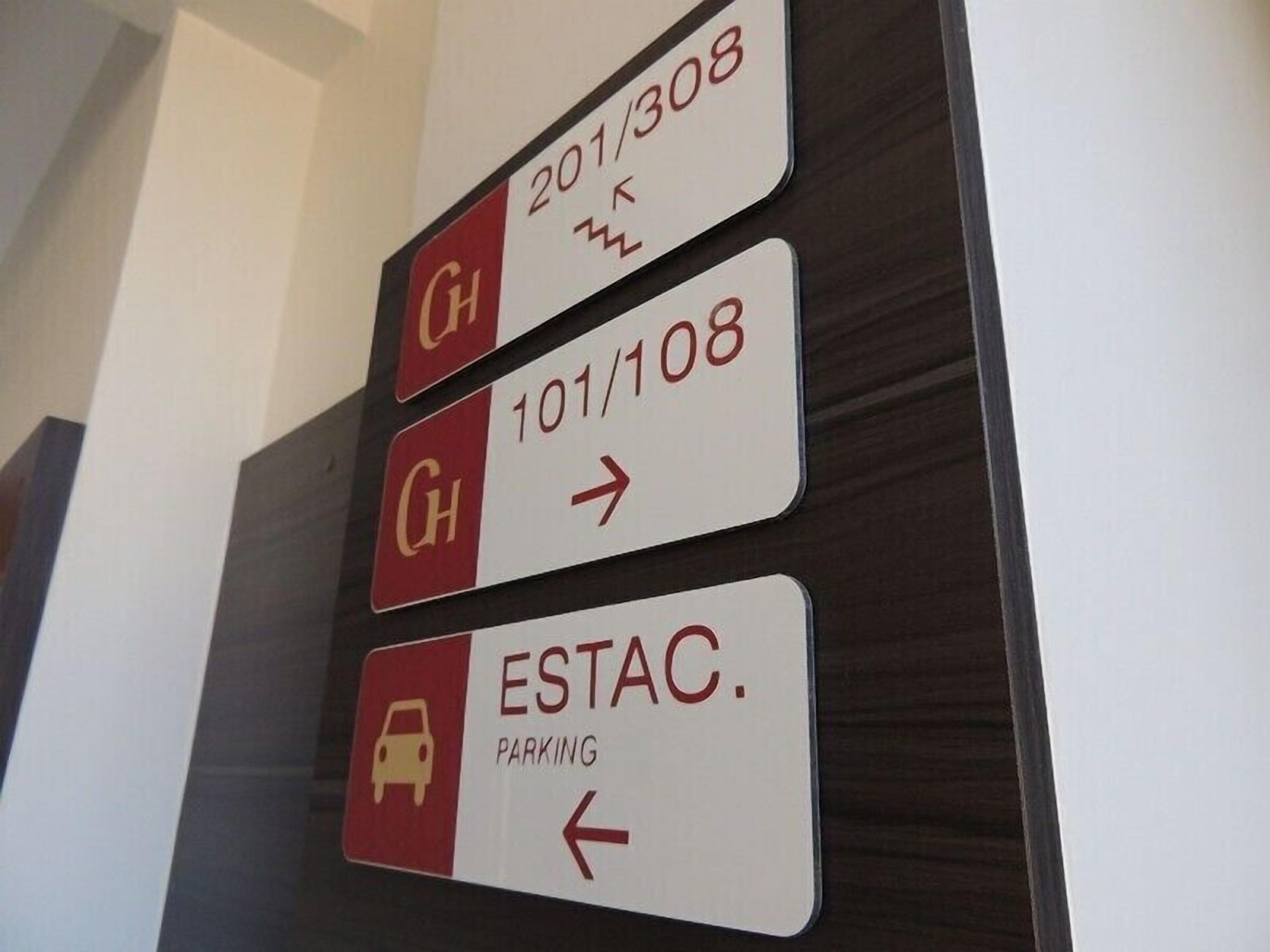 Directional signs for hotel rooms and parking.