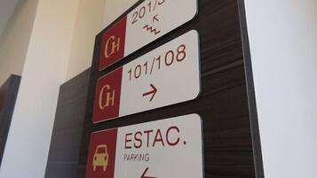 Directional signs for hotel rooms and parking.