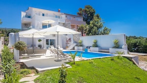 A modern villa with a swimming pool, outdoor seating, and a well-maintained garden. - Villa Andrea (Punat)