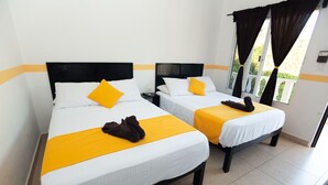 Two single beds with white and yellow bedding, black headboards, and a window with curtains. - Nicol-Haa (Izamal)
