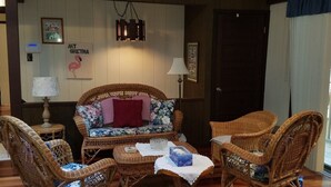 A room with wicker furniture, including a sofa and chairs, a small table, and a lamp. - Big house, big yard, close to everything in Mount Gretna! (Mt Gretna)