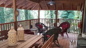 A wooden deck with a table and chairs, a ceiling fan, and a view of greenery. - Big house, big yard, close to everything in Mount Gretna! (Mt Gretna)