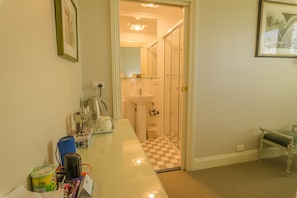 Un baño con cabina de ducha de vidrio, un lavabo y un espejo.