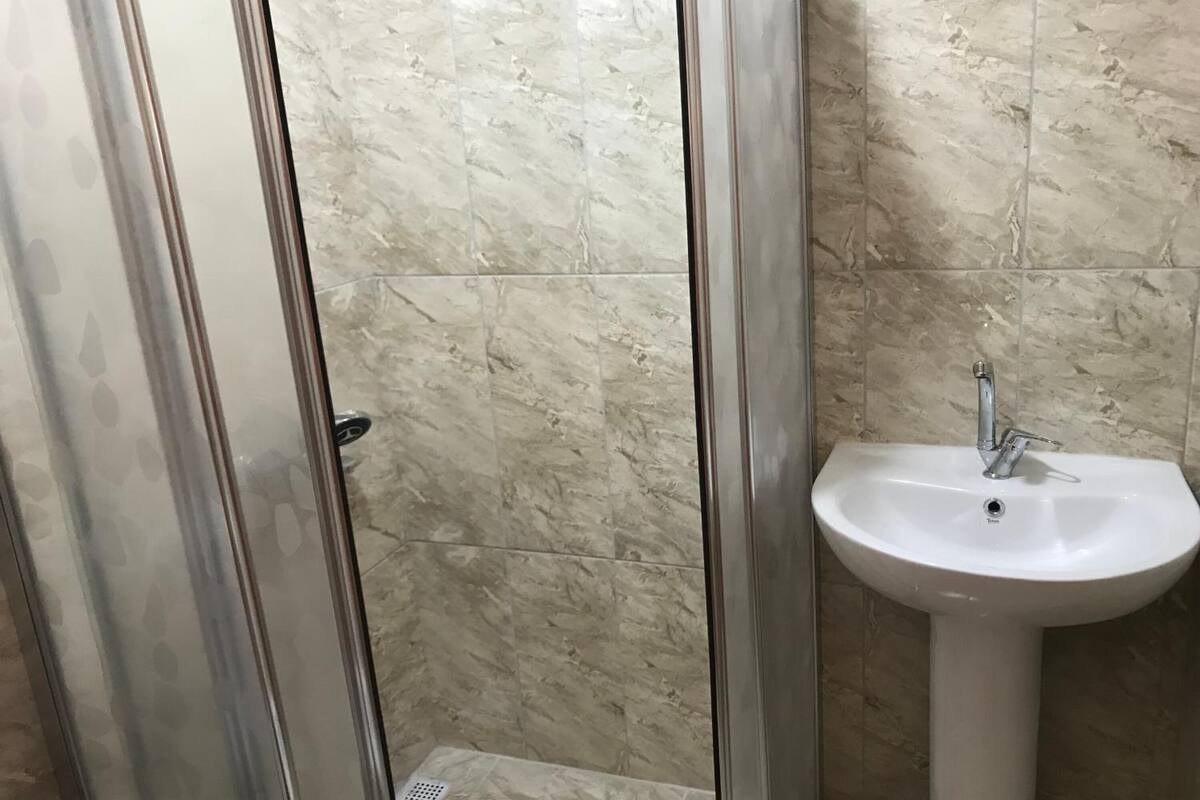 shower, hair dryer, slippers, towels