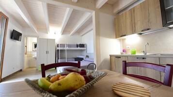 Full-sized fridge, stovetop, cookware/dishes/utensils