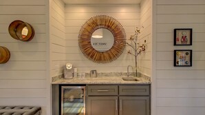 A modern kitchen with a built-in oven, a coffee maker, and a sink. - Sweet Tea Cottage at Julep Farms (Dillard)