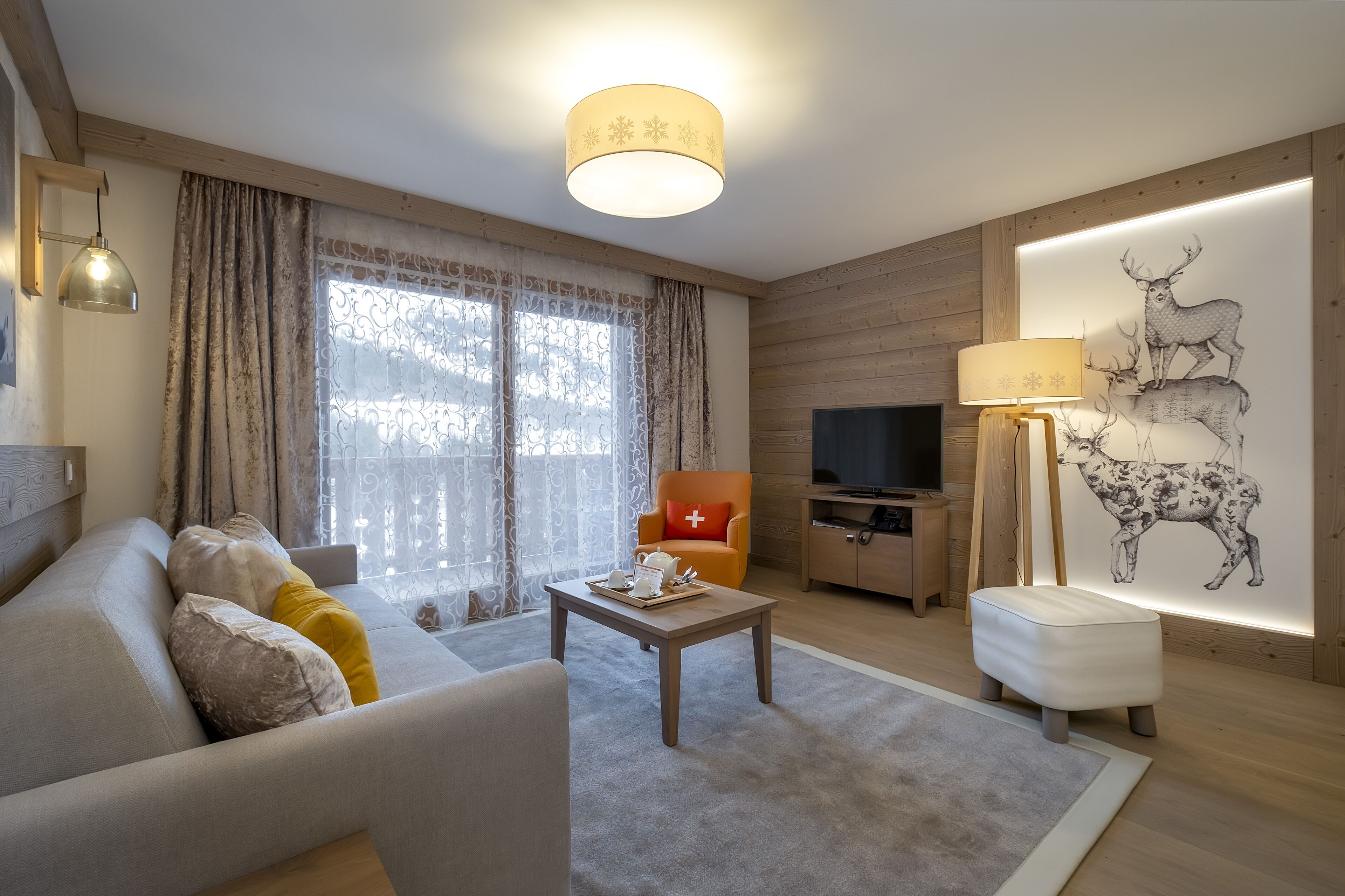 A modern living room with a sofa, coffee table, and a television.